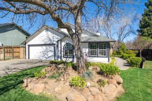 a house with a tree in the front yard at Martinique in Redding