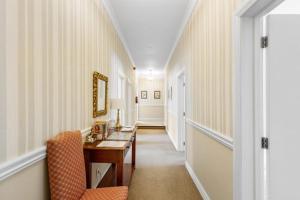 a hallway with a table and a chair in a room at The Station in Hunterville