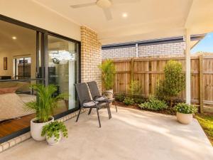 a patio with a bed and some plants at Spacious 4B Near Logan with Parking in Marsden