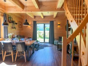 a dining room with a table and a staircase at Rattendorf 3A in Rattendorf