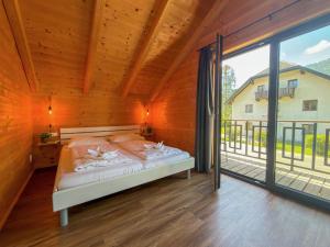 a bedroom with a bed and a large window at Rattendorf 3A in Rattendorf