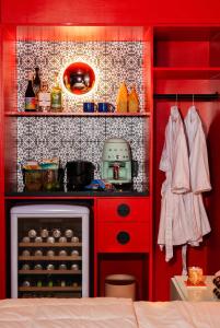 a small kitchen with red cabinets and a stove at Hotel Hilo - Room 202 in Louisville