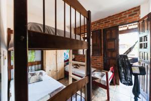 a room with a bunk bed and a staircase at Cacau Biruta in Itacaré
