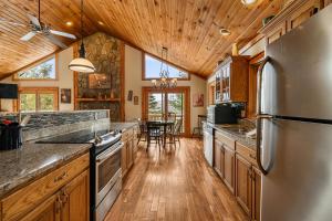 a large kitchen with wooden floors and a wooden ceiling at North View Lodge High Country in Banner Elk