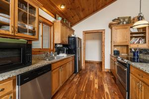 a kitchen with wooden cabinets and stainless steel appliances at North View Lodge High Country in Banner Elk +42 photos