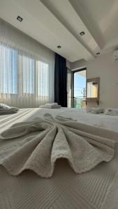 a large bedroom with a large bed with a blanket at The Brothers Suite Dalaman in Dalaman +29 photos