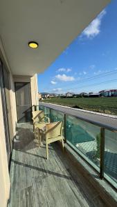 a balcony with two chairs and a view of the ocean at The Brothers Suite Dalaman in Dalaman