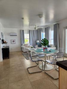 a living room with a table and chairs at The Sands Hotel in Cockburn Town
