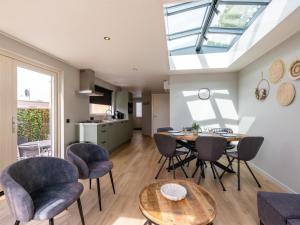 a kitchen and living room with a table and chairs at t Sluisje 8 in Bantega