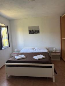 a bedroom with a bed with two towels on it at GrappoloNero in Laino Castello +40 photos