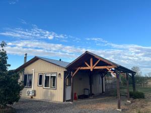 a small shed with awning on top of it at Cabañas Campestres Inés in Chillán