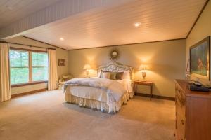 a bedroom with a bed and a large window at Pinnacle View Lodge in Boone