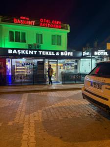 a man is walking in front of a restaurant at Başkent otel in Mudanya +1 photo