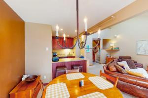 a living room with a table and a couch at Cozy Modern Comfort in Killington +50 photos
