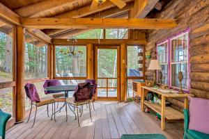 a dining room with a table and chairs in a cabin at Wood Road Retreat in Quechee