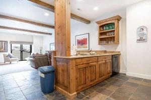 a kitchen with a large wooden island in a room at Classic Ski-in Ski-out Condo in Park City