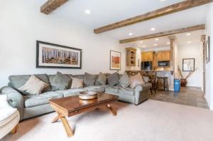 a living room with a couch and a table at Classic Ski-in Ski-out Condo in Park City