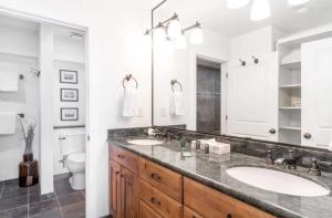 a bathroom with two sinks and a toilet at Classic Ski-in Ski-out Condo in Park City +22 photos