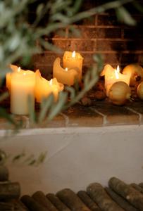 a group of candles sitting on top of a fireplace at Hotel Antonios in Olympia