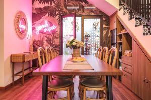 a dining room with a wooden table and chairs at Kalysandria Home in Padasul