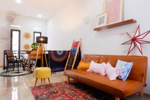 a living room with a brown couch and a table at Kalysandria Home in Padasul