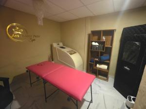 a sewing room with a red table and a sewing machine at Amanecer Petit in Miramar