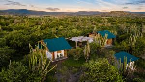 an aerial view of a house with blue roofs at Bosque Seco Bioreserva & Hostel in Villavieja