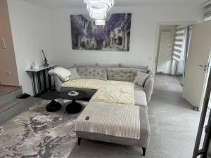 a living room with a couch and a table at Modernes Appartment in Schifflange in Schifflange