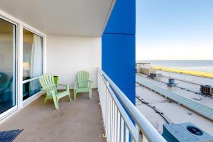 a balcony with two chairs and a view of the ocean at Carousel 706 in Ocean City