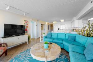 a living room with a blue couch and a table at Carousel 706 in Ocean City