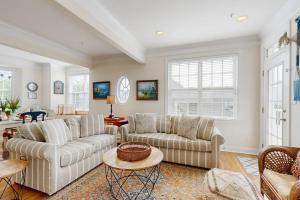 a living room with two couches and a table at 16 The Palms in Ocean City