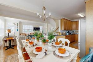 a dining room and kitchen with a white table and chairs at 16 The Palms in Ocean City