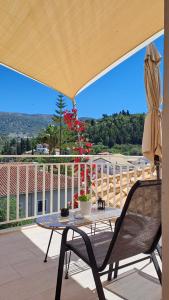 a patio with a table and a patio umbrella at Cruzeto in Syvota