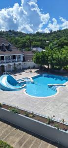a large swimming pool with a slide in a yard at Studio Suite 11 in Ocho Rios