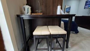 a wooden bar with two stools under it at Studio Suite 11 in Ocho Rios +6 photos