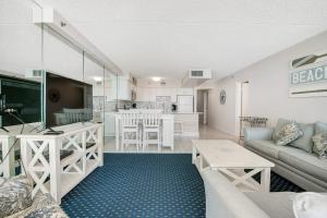a living room with a couch and a kitchen at Carousel 1605 in Ocean City
