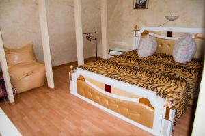 a bedroom with a tiger print bed with a couch at Holiday Home near sea in Odesa