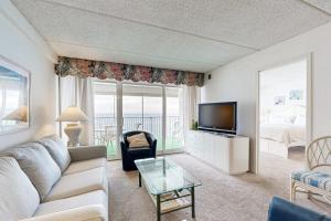 a living room with a couch and a tv at English Towers 804 in Ocean City