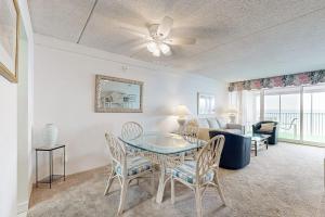 a living room with a table and chairs and a couch at English Towers 804 in Ocean City
