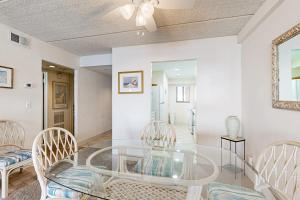 a dining room with a glass table and chairs at English Towers 804 in Ocean City +33 photos