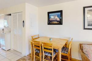 a dining room with a wooden table and chairs at Jamaica Bay 105A in Ocean City