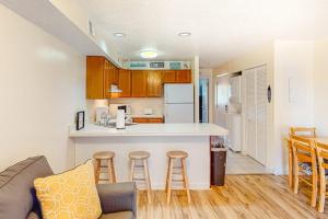 a kitchen and living room with a couch and a counter at Jamaica Bay 105A in Ocean City