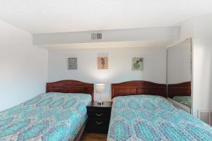 a bedroom with two beds and a mirror at Jamaica Bay 105A in Ocean City +11 photos