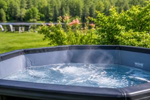 a hot tub filled with water in a yard at Paddle & Pine in Bleecker