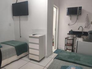 a bedroom with a bed and a sink in it at Quarto Privativo com ar condicionado no centro in Ribeirão Preto