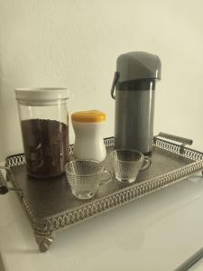 a tray with a coffee maker and cups on it at Quarto Privativo com ar condicionado no centro in Ribeirão Preto +27 photos