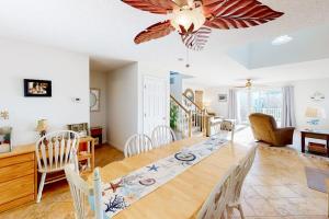 a dining room and living room with a table and chairs at 604 Seaweed Lane #1 in Ocean City