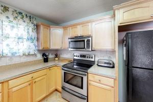 a kitchen with wooden cabinets and a stove and microwave at 604 Seaweed Lane #1 in Ocean City