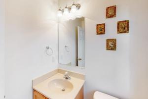 a bathroom with a sink and a mirror at 604 Seaweed Lane #1 in Ocean City +14 photos
