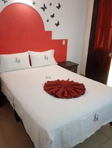 a bedroom with a bed with a red headboard at J Alejandro - Centro Histórico Guadalajara in Guadalajara